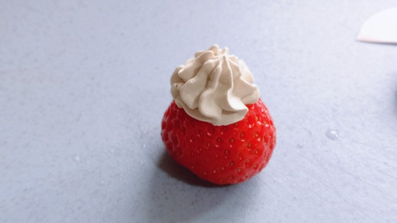 圣诞老人可可草莓杯子蛋糕,在草莓底部挤上奶油，再把切下来的尖做帽子。