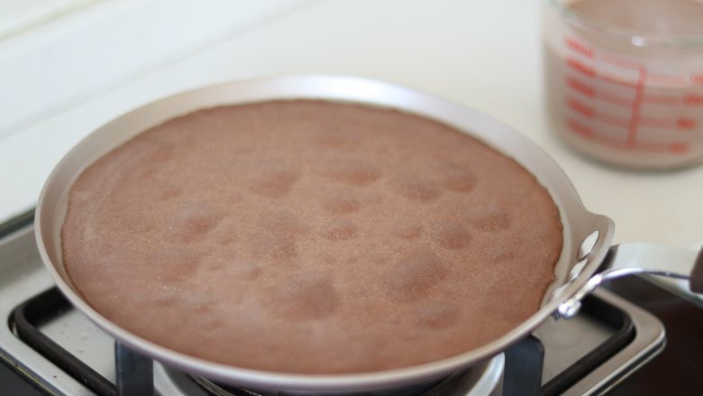 巧克力毛巾卷,直到有大的泡泡起来，不用翻面。直接倒扣到保鲜膜上。