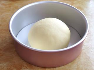奶酪包,将面团揉圆后，放入8寸戚风蛋糕模具中，发酵40分钟左右。