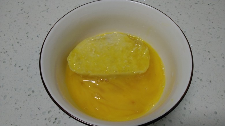 香煎馍片,放入馍片，使馍片均匀粘上蛋液。
