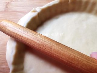 肉桂苹果派,取大的面团，用擀面杖擀成薄片后铺在派盘上，用手轻压派皮，使其能紧贴派盘，随后用擀面杖把多余的派皮切断