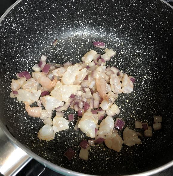 南瓜海鲜豆腐起司燉饭,加点油炒香洋葱，炒到熟透。
再加入切碎的虾子炒熟