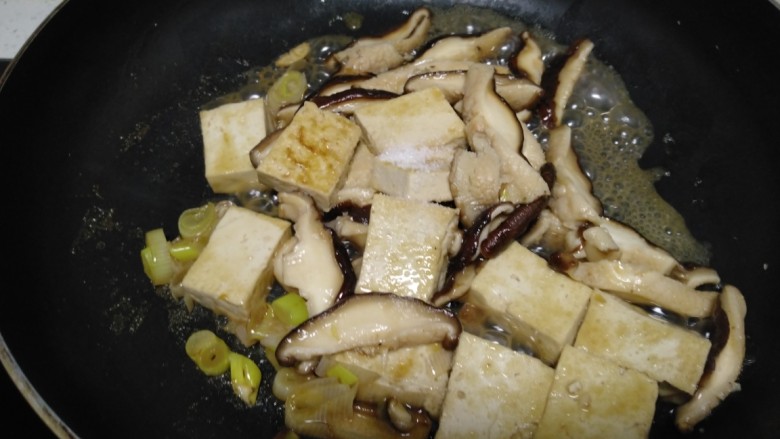 豆腐炒香菇,加入盐。