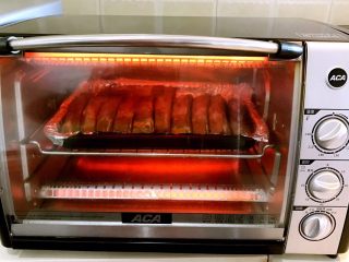 #猪肋排#  秘制香辣烤肋排,烤箱200W预热5分钟，把烤盘放入烤箱里，上下火200W烤10分钟
