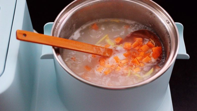 养生又养胃的生滚杂蔬鱼片粥,这个时候加入提前切碎的胡萝卜和姜丝，继续用小火炖煮5分钟左右。