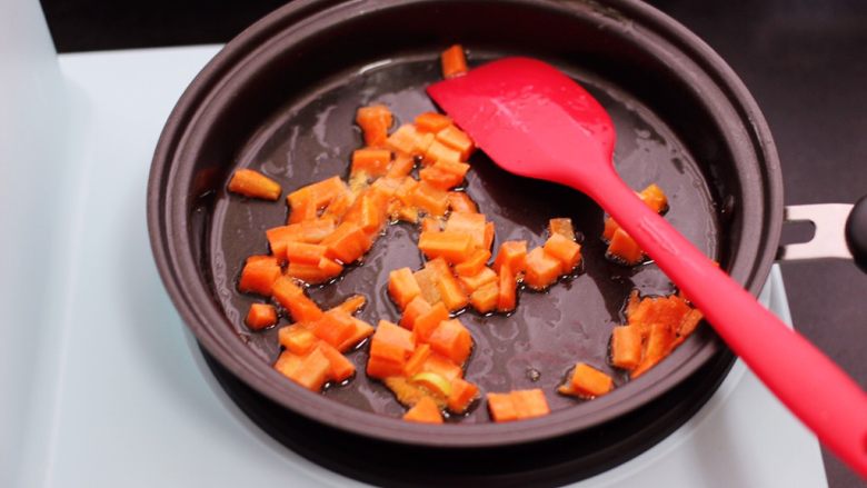 补钙又营养的虾仁豆芽蛋炒饭,锅烧热后重新加入15克花生油，把胡萝卜丁先用小火慢慢炒至变软后。