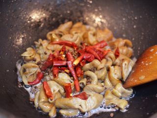 爆炒肥肠,放入干辣椒和花椒翻炒均匀。