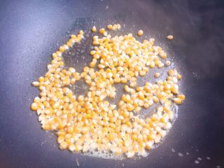 自制爆米花,用勺子拌匀，让每粒玉米都沾上黄油。