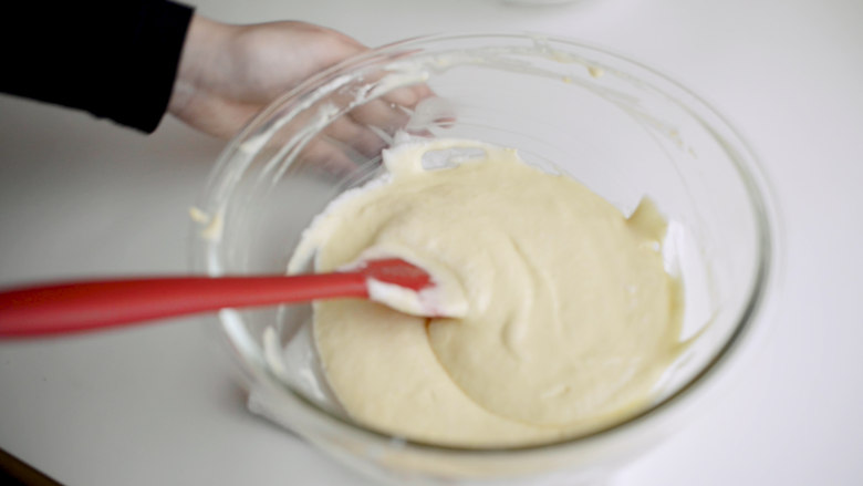 焦糖布丁轻乳酪蛋糕,将蛋白霜和蛋黄糊翻拌均匀。