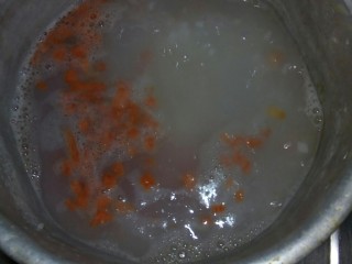 鸡肝彩蔬粥,米煮开后，放胡萝卜粒熬粥。