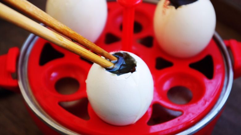 琥珀鸡蛋,用筷子将小块的松花蛋若干块夹到鸡蛋里，用筷子轻轻的往里戳戳松花蛋。