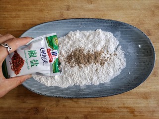 椒盐鳎米鱼,适量裹炸粉放入盘中，再加入适量的椒盐，搅拌均匀。没有裹炸粉可以用生粉和玉米淀粉按2：1比例混合均匀代替。