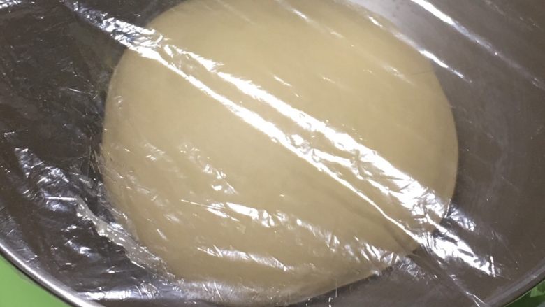 奶酪双吐司,整理滚圆，放入桶内盖上保鲜膜。