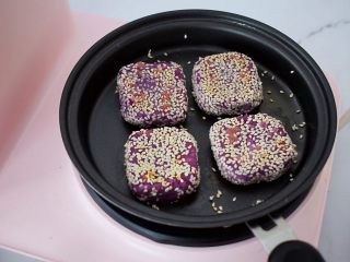 奶香紫薯饼,翻面撒上1勺水，继续煎至水干，直至熟透后盛出即可