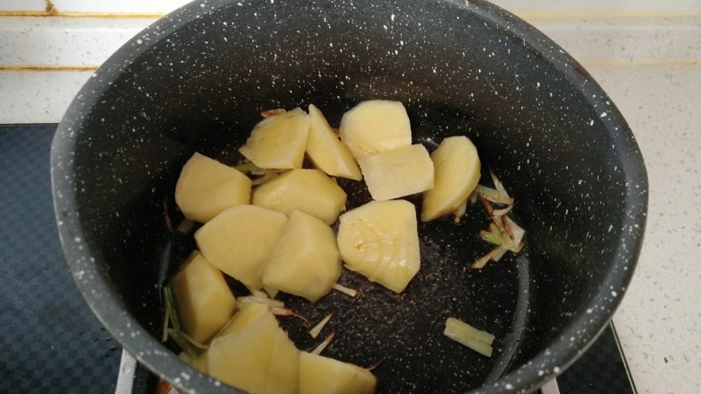 咖喱牛肉饭,倒入土豆翻炒均匀。