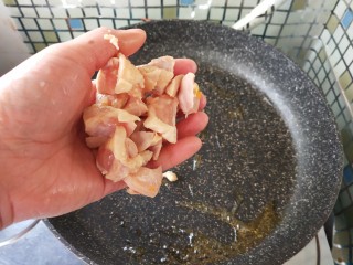 奶香南瓜鸡肉焗饭,热锅放入油，放入鸡丁，炒至微微焦黄。