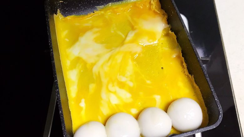 黑芝麻汤圆厚蛋烧,蛋液稍微凝固就放入煮好的汤圆