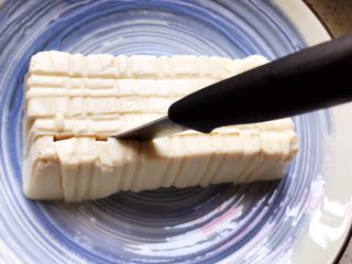 鲍鱼干贝XO酱拌香椿皮蛋豆腐,用刀将豆腐划成片