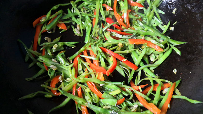眉豆炒辣椒,要适当喷洒一点温水，防止糊锅，眉豆比较硬，不太易熟，所以要多炒一会，

