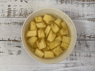 菠萝咕咾肉,菠萝切成小块儿，放到盐水里浸泡备用