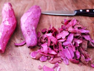 紫薯酸奶果仁芝麻饼,然后把紫薯用刀去皮。