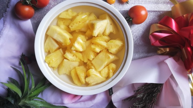 冰爽菠萝块,盖上保鲜膜，放入冰箱冷藏半小时以上，即可食用，冰冰凉又香又甜的菠萝就做好啦！