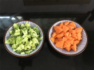 西兰花肉松饭团,胡萝卜去皮清洗干争后切成小粒，西兰花清洗干净后用淡盐水浸泡一下后掰成小小朵。