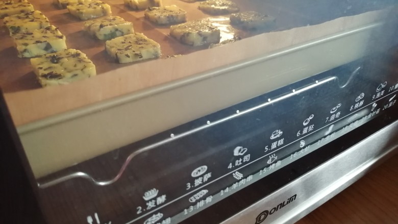 海苔香葱饼干,放在烤盘上，放入已经预热到160度的东菱烤箱中下层，烘烤18分钟左右