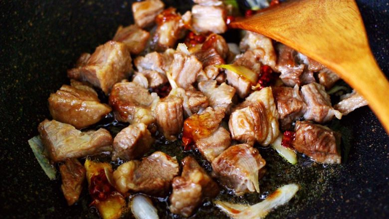 红烧牛肉炖大蒜,这个时候放入焯水的牛肉块，大火翻炒片刻。