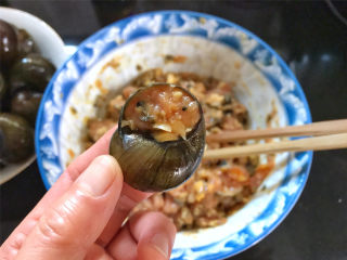 香辣田螺塞肉,再把拌好的肉塞入洗净的田螺壳中，盖上厣。