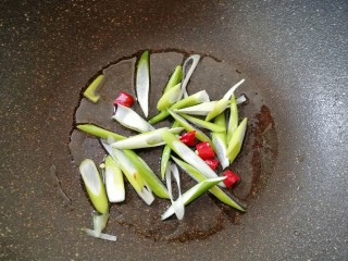 茄汁土豆丝,炒锅内倒适量的食用油烧热，下入葱丝和干红辣椒炒香。