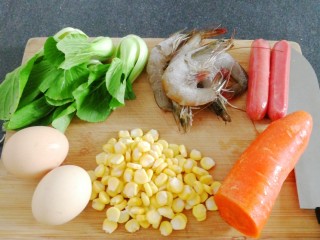 炒饭,煮饭时，我们准备有上海青， 虾，半根胡萝卜，双汇火腿肠，玉米粒，鸡蛋。