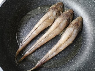 亚麻籽粉饽饽煎鱼,平底煎锅中加入适量的油，烧热后把腌制好的鱼入锅。