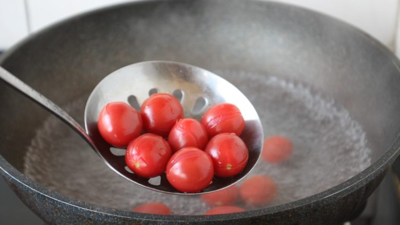 陈皮小番茄,水开后下入小番茄焯水，然后过凉水。 焯水时间一定要短，8秒钟即可。