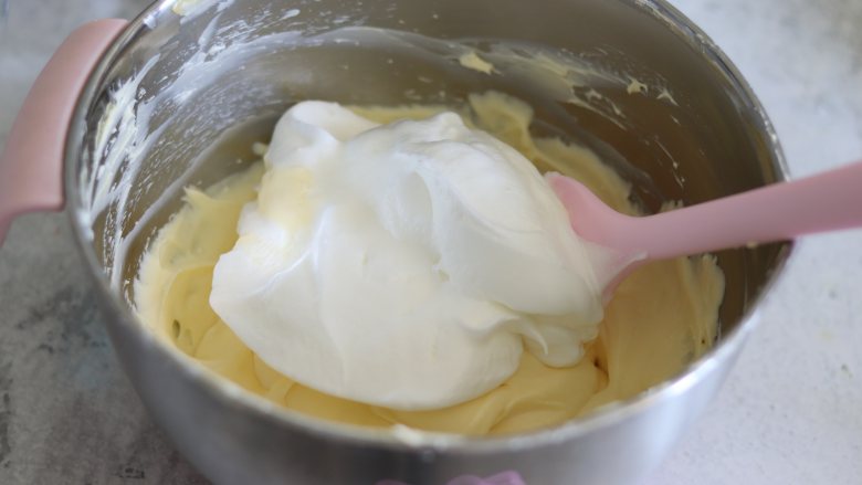舒芙蕾芝士蛋糕,之前做好的奶酪糊，再搅拌几下到顺滑。
取1/3的蛋白霜和奶酪糊拌匀。
再和剩余的蛋白霜翻拌匀。