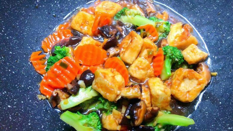 杂蔬豆腐,倒入豆腐，西兰花，胡萝卜快速翻炒均匀，把全部汤汁吸收到菜里即可。