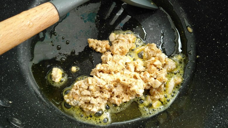 咸蛋芦笋火腿焗土豆,热锅放油放入咸蛋小火煸炒