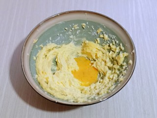 翡翠黄油饼干,分两次加入全蛋液，继续启动电动打蛋器，打至蛋液与黄油完全融合，再加入一半蛋液，同样打至完全融合即可。