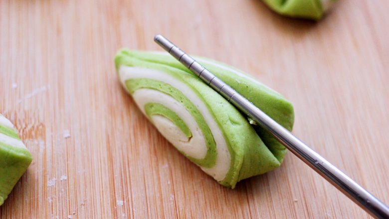 双色菠菜花样馒头,用一根筷子从切好的三角形的形状中间使劲压一下，美美哒的可可双色花样馒头就做好了。