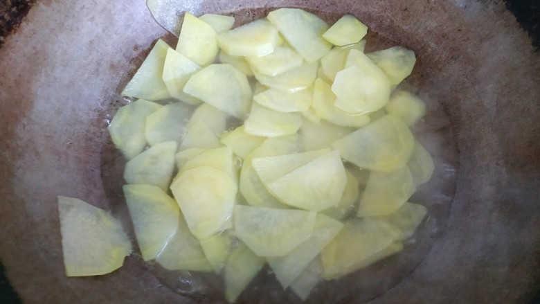 土豆豆角炒五花肉,土豆片放入锅中煮至透明