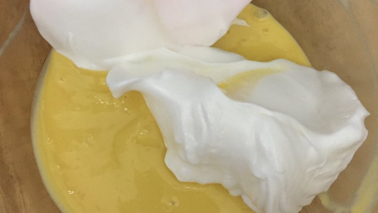 卡通小蛋糕,将3分之1的蛋白霜加入到蛋黄糊中，用翻拌的方式将面糊拌匀。