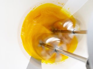 香蕉蛋黄溶豆,中高速打至蛋黄慢慢变白，有些纹路，开始转中低速继续打蛋黄。