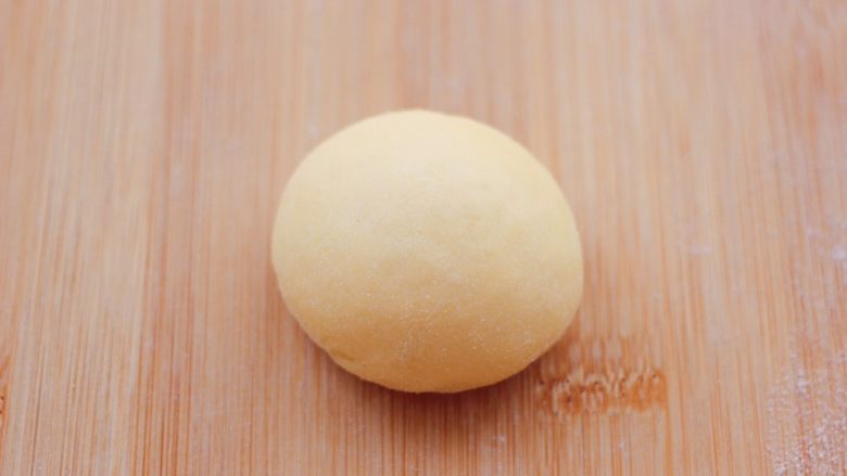 胶东喜饼,取一个面团用手反复揉搓均匀，揉的时间越长，做出来的喜饼口感越好，看见面团细腻光滑的时候，揉成圆形面团。