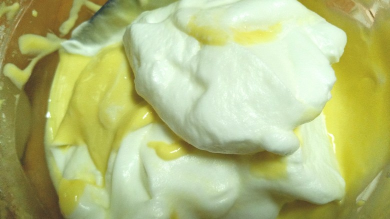 蒸酸奶蛋糕,取一半蛋白入蛋黄糊中翻拌均匀，在加入另一半蛋白继续翻拌