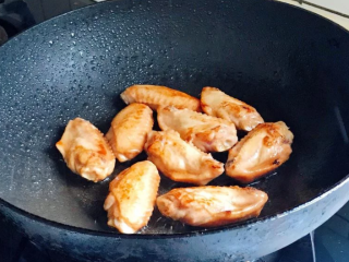 照烧鸡翅,醃好的鸡翅用中小火慢煎，煎至两边呈金黄色即可。（裡面没熟透也没关係，等一下还要燜煮）