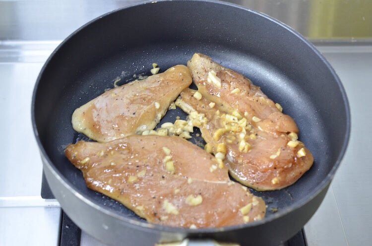 蒜香蜜汁黑椒鸡排,将鸡胸肉连同汤汁一起倒入锅中，盖盖 小火慢煎