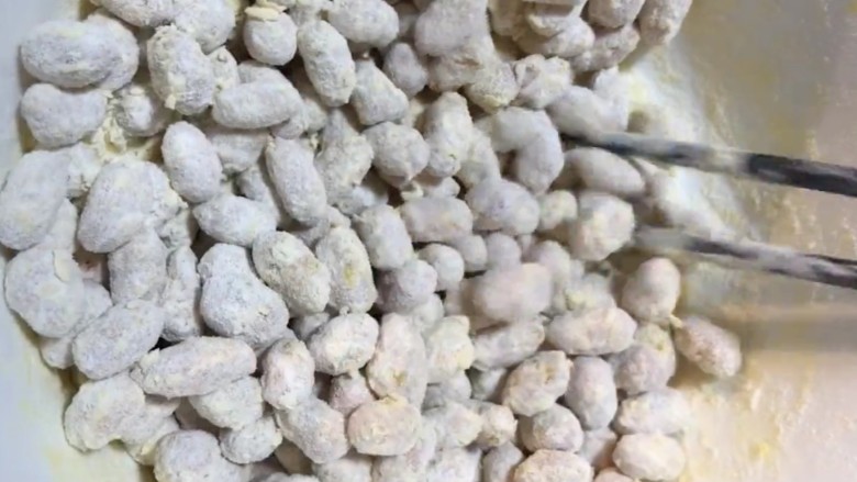 糖霜花生米,将花生均匀的蘸裹面粉