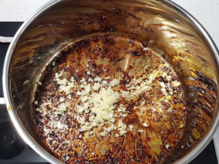 蒜香蜂蜜啤酒鸡翅,原锅内加入蒜末，利用煎鸡翅的鸡油稍微拌炒。