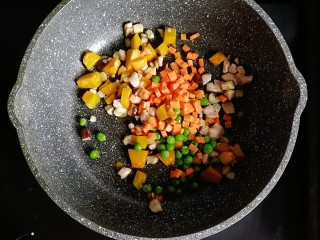 南瓜肉末炒饭,倒入胡萝卜丁和豌豆翻炒均匀