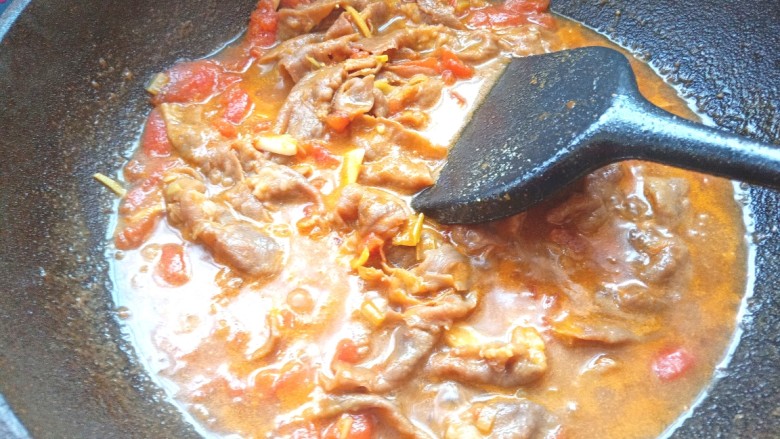 番茄酸汤肥牛,牛肉片变色，放入少许盐翻炒均匀，关火